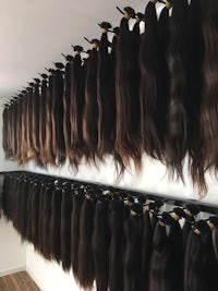 many long hairs hanging on a wall in a store